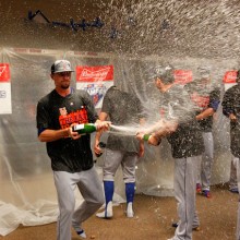 CINCINNATI, OH - SEPTEMBER 27: Members of the New York Mets celebrate with champagne in the clubhouse after defeating the Cincinnati Reds 10-2 to clinch the National League East Championship at Great American Ball Park on September 26, 2015 in Cincinnati, Ohio.  (Photo by John Sommers II/Getty Images)