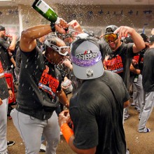 CINCINNATI, OH - SEPTEMBER 27: Ricky Bones #25  and Jon Niese #49 of the New York Mets spray champagne on teammates as they celebrate in the clubhouse after defeating the Cincinnati Reds 10-2 to clinch the National League East Championship at Great American Ball Park on September 26, 2015 in Cincinnati, Ohio.  (Photo by John Sommers II/Getty Images)